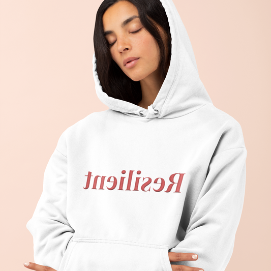 Person wearing a white hoodie with red text on a beige background